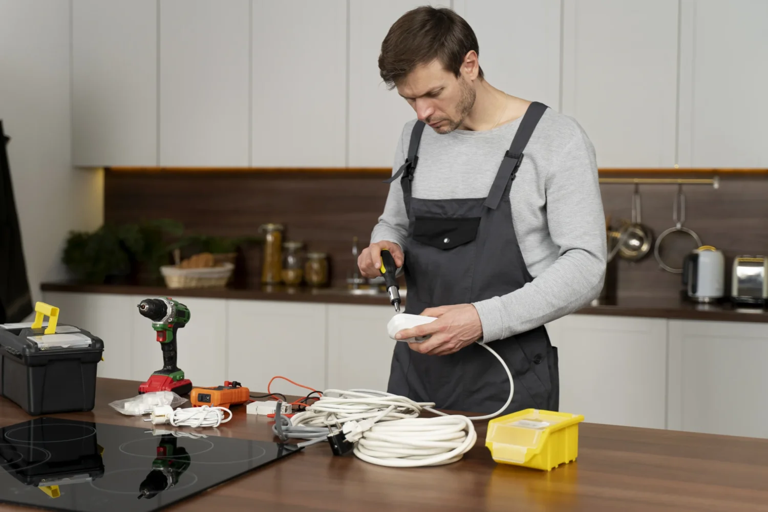 Technician repairing kitchen appliances including oven and microwave in Albany NY