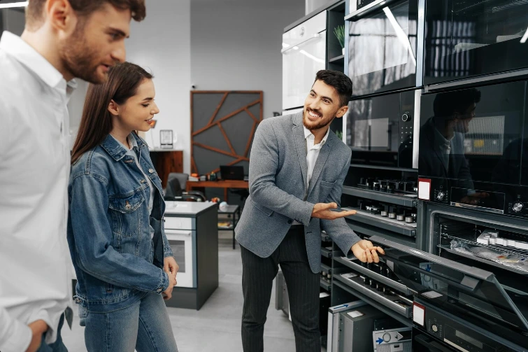 Technician explaining appliance replacement options to a homeowner in Albany NY