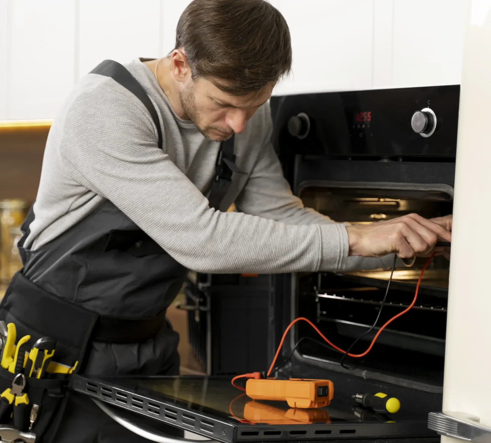 Appliance repair technician inspecting a household appliance in Albany NY